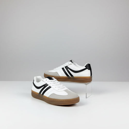 White sneakers with black and tan accents on white background