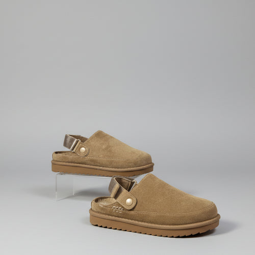 Pair of brown shoes with straps on back on a white background
