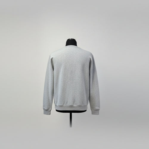 Gray sweater on a mannequin against a plain background