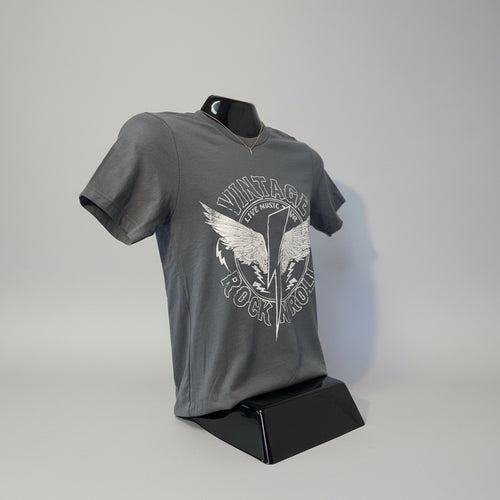 Gray t-shirt with graphic design on a mannequin against a white wall.