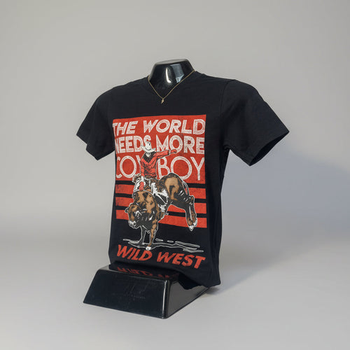 Black t-shirt with a graphic of a cowboy riding a bull and text 'The World Needs More Cowboy Wild West' on a white background.