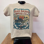 Beige t-shirt with colorful graphic design on a white surface