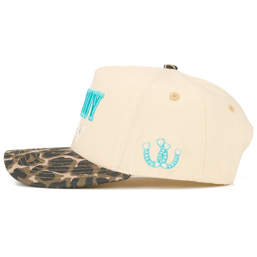 Beige cap with leopard print brim and turquoise logo on a white background
