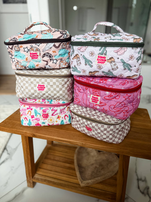 Set of colorful insulated lunch bags stacked on a wooden table.