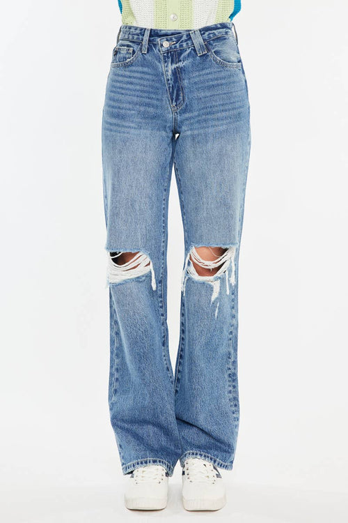 Ripped blue jeans on a white background