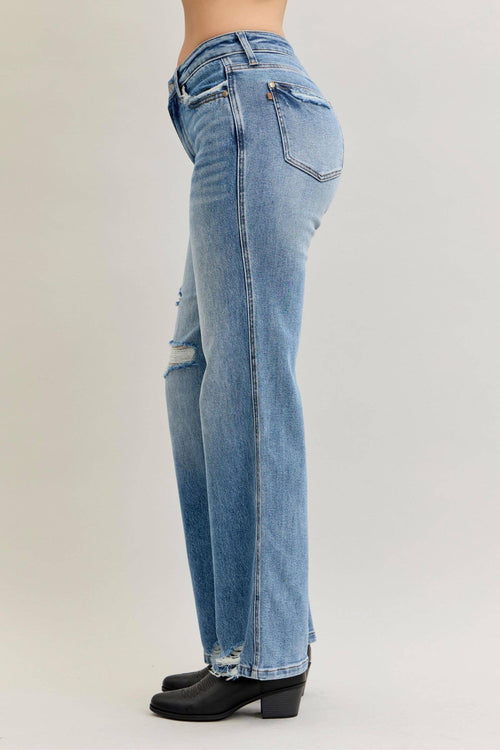 Light blue jeans worn by a person on a white background