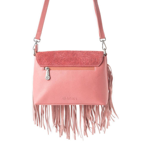 Pink crossbody bag with fringe details on a white background