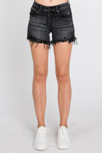 Black denim shorts worn by a person on a white background