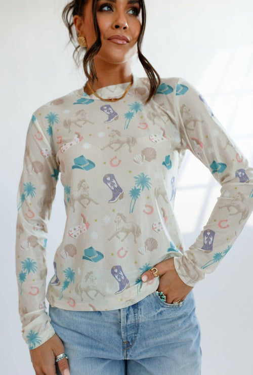 Woman wearing a long-sleeve shirt with colorful patterns on a white background