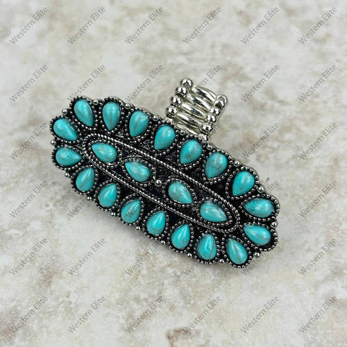 Turquoise stone hair clip on a textured beige background