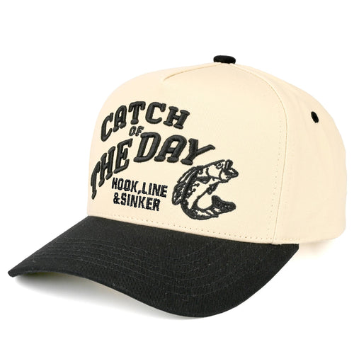 Beige and black hat that says "catch of the day" on a white background