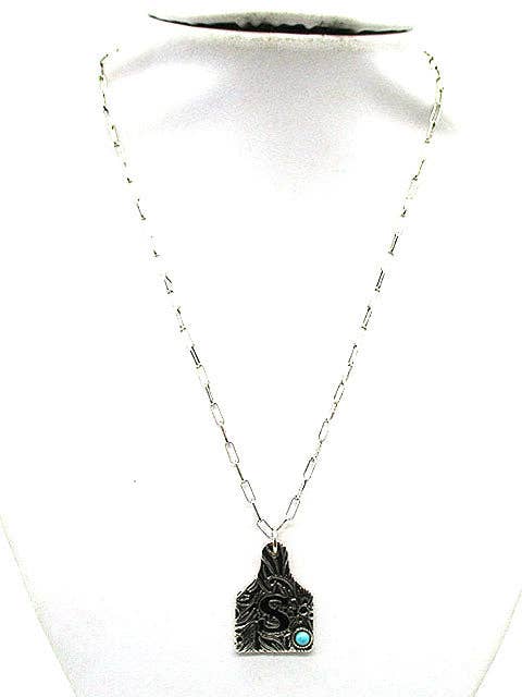 Necklace with a pendant on a white mannequin bust