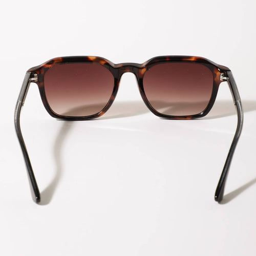 Sunglasses with tortoiseshell frame and brown gradient lenses on a white background
