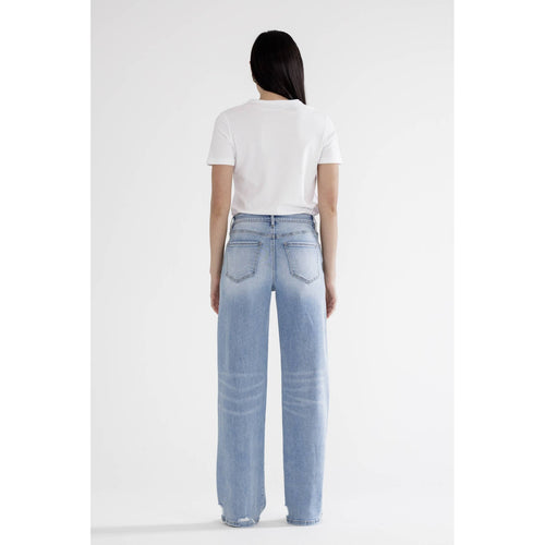 Person wearing light blue jeans and a white t-shirt on a white background