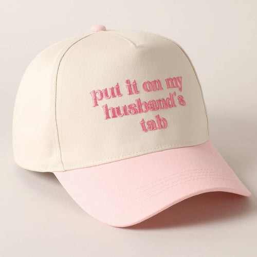 Beige and pink cap with text 'put it on my husband's tab' on a light background
