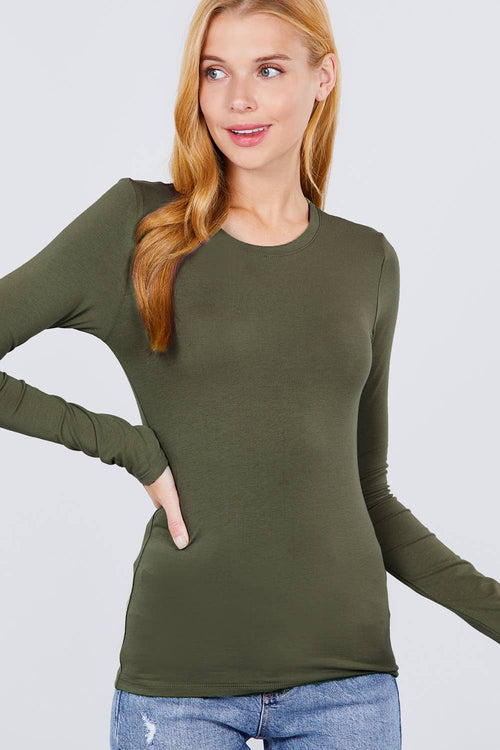 Woman wearing an olive green long-sleeve top against a light gray background