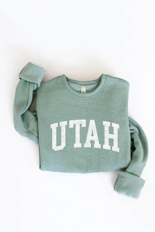 Green sweatshirt with 'UTAH' printed on it against a white background