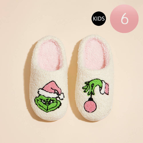 Pair of children's slippers with Grinch design on a beige background