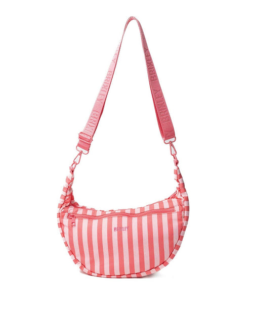 A pink and white vertically striped crescent-shaped shoulder bag with a matching pink strap, shown against a plain white background.