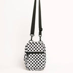Black and white checkered crossbody bag on a light gray background
