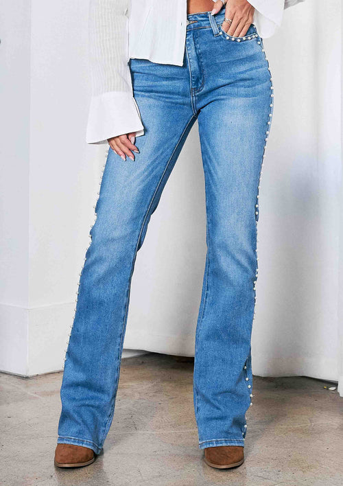 Person wearing blue jeans with a white background