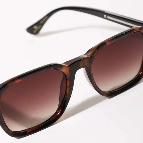Sunglasses with tortoiseshell frame and brown lenses on a white background