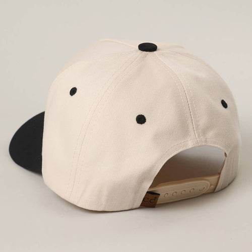 Beige baseball cap with black buttons on a light gray background