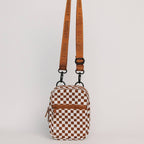 Checkered pouch with a brown strap on a light gray background