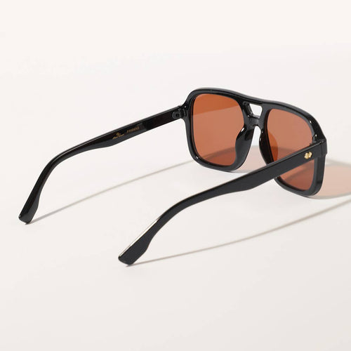 Black sunglasses with brown lenses on a white background