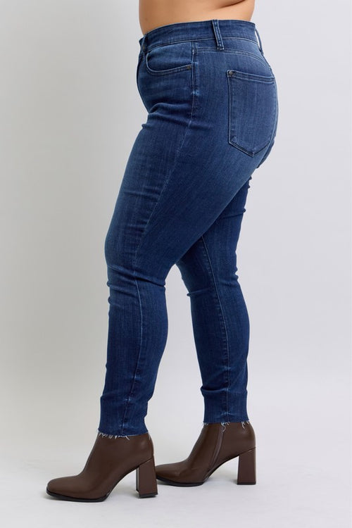 Blue jeans worn by a person on a white background