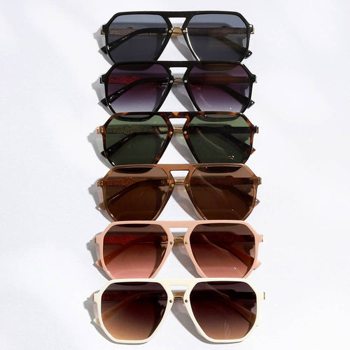 Set of five different colored sunglasses stacked on a white background