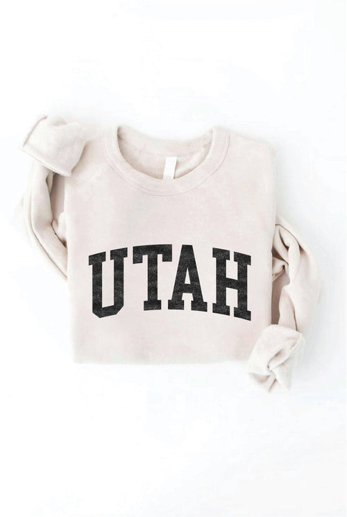 Beige sweatshirt with 'UTAH' printed on it against a white background