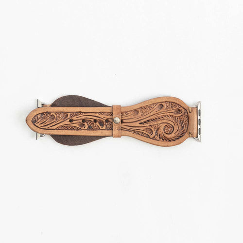 Decorative leather watch band with intricate patterns on a white background