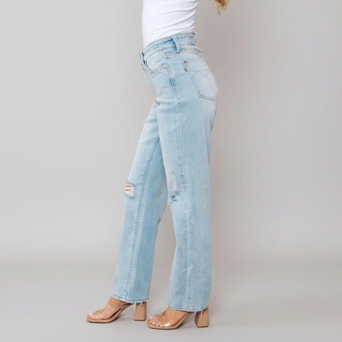Light blue jeans worn by a person with a white background 