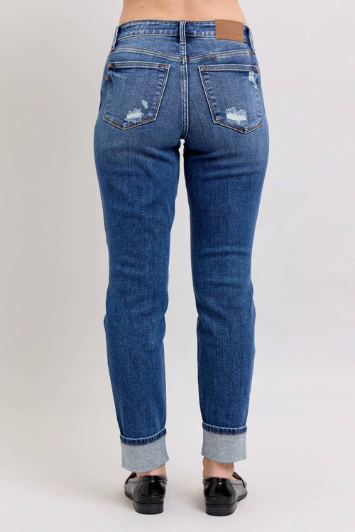 Blue jeans with a slight distressed look on a plain background