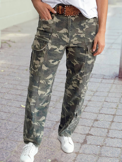 Person wearing camouflage pants on a paved surface