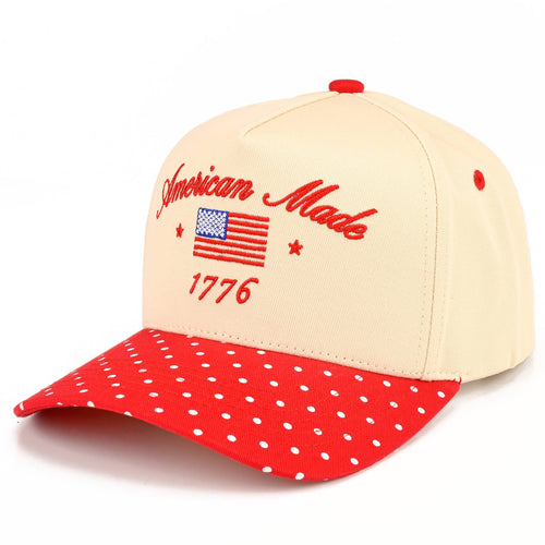 Cap with 'American Made 1776' text and American flag design on beige and red polka dot fabric.