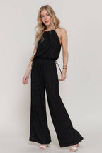 Woman wearing a black jumpsuit on a white background