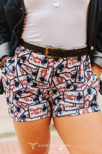 Shorts with cowboy pattern and 'Lucky & Blessed' branding.