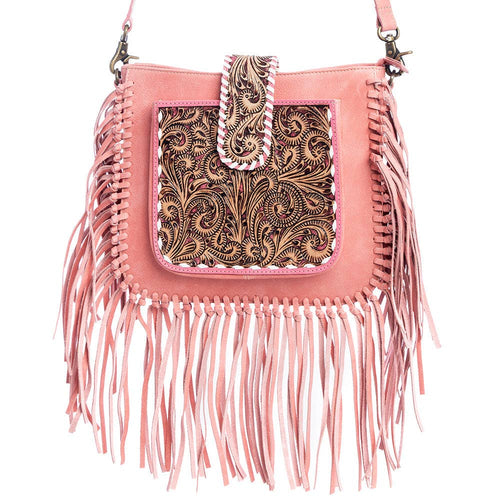 Pink handbag with fringe and intricate tooled leather design on a white background