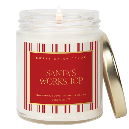 Candle in a jar with a red label reading 'Santa's Workshop' by Sweet Water Decor.