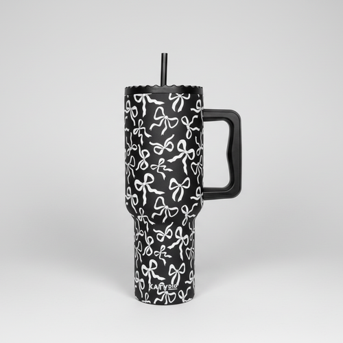 Black tumbler with white bow pattern and handle, featuring the brand 'KATYDID'.