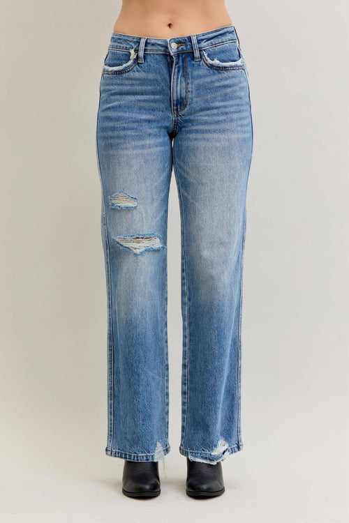 Blue jeans with slight distressing on a plain background