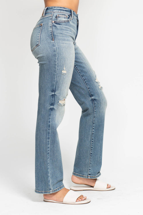 Light blue jeans worn by a person on a white background