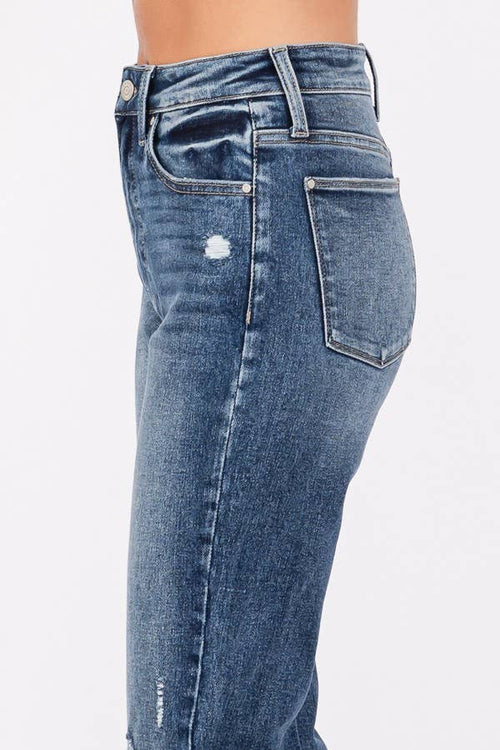 Blue jeans with a slight distressed look on a white background