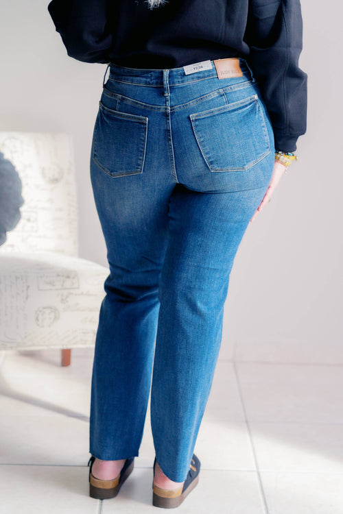 Person wearing blue jeans with a blurred background