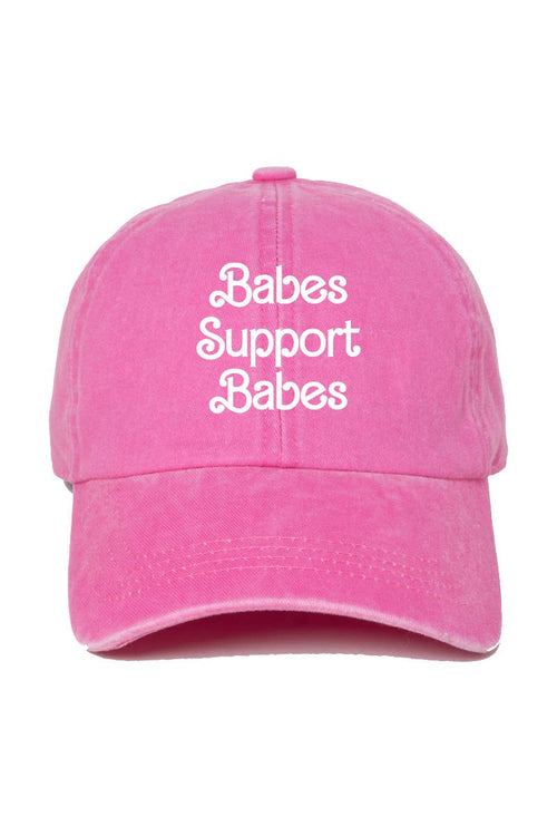 A pink baseball cap with the phrase 'Babes Support Babes' embroidered in white script across the front, shown against a plain white background.