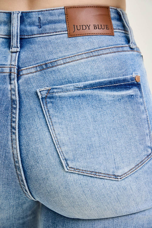Close-up of blue jeans with a Judy Blue label on the waistband.