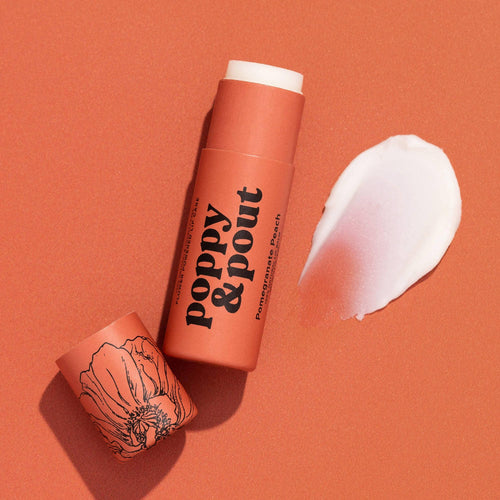 Lip balm with 'Poppy & Pout' branding on an orange background
