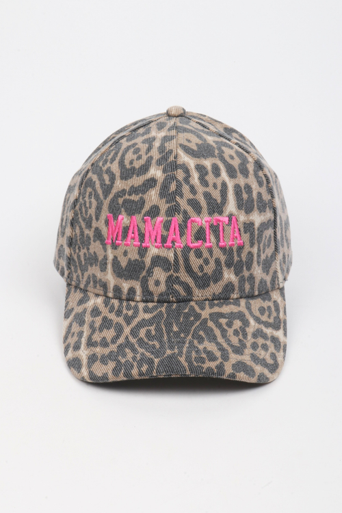 A baseball cap with a beige and gray leopard print pattern, featuring the word 'MAMACITA' embroidered in bright pink across the front.